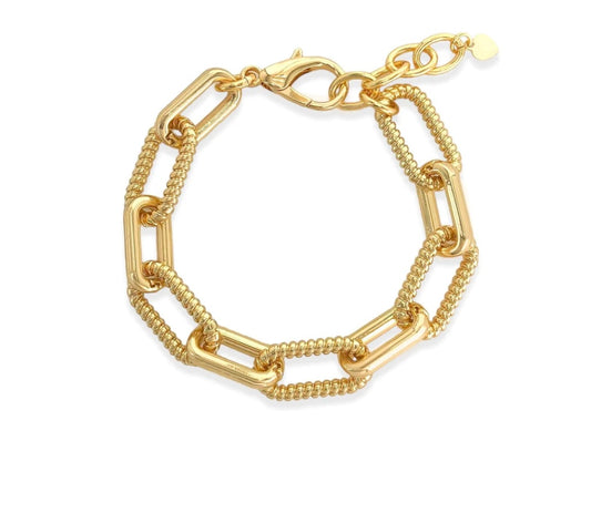 Paperclip chain bracelet with unique alternating ribbed link design, 18k gold plated. Approx. 0.5" thick, 7" length with 1.5" extension, lobster clasp closure. Pair with matching necklace for a complete look.